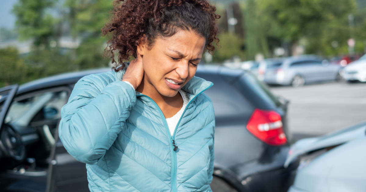 Woman clutches neck in front of fender bender